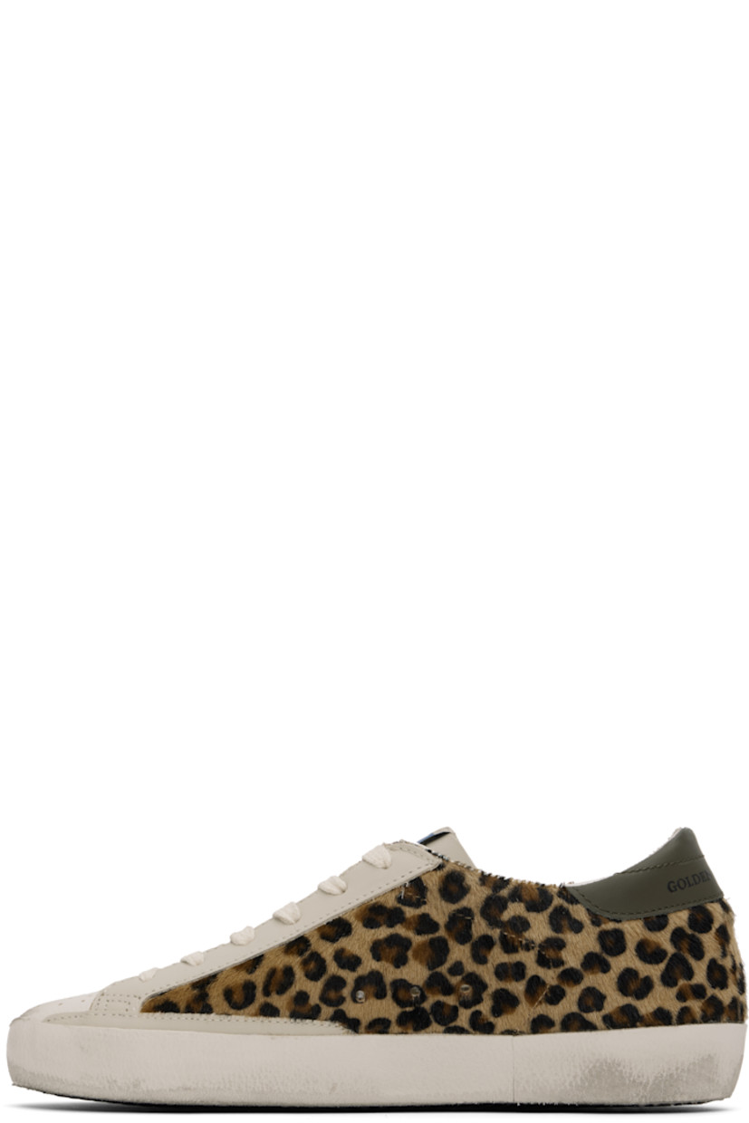 Handcrafted low-top paneled hair-on leather and buffed leather sneakers in tan. Smudging, perforated detailing, and leopard pattern printed throughout.

· Lace-up closure
· Logo patch at tongue
· Padded collar
· Signature star appliqué at outer side
· Gold-tone logo stamp at outer side
· Logo printed at heel tab
· Suede, buffed leather, and terrycloth lining
· Treaded rubber sole

Supplier color: Beige/Brown/Black