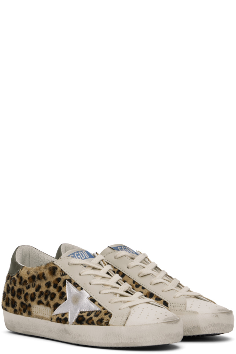 Handcrafted low-top paneled hair-on leather and buffed leather sneakers in tan. Smudging, perforated detailing, and leopard pattern printed throughout.

· Lace-up closure
· Logo patch at tongue
· Padded collar
· Signature star appliqué at outer side
· Gold-tone logo stamp at outer side
· Logo printed at heel tab
· Suede, buffed leather, and terrycloth lining
· Treaded rubber sole

Supplier color: Beige/Brown/Black