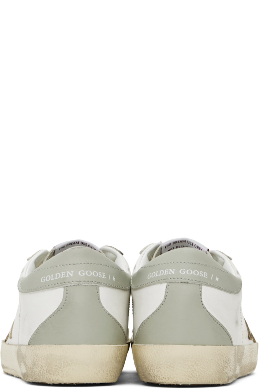 Handcrafted low-top buffed leather sneakers in white.

· Smudging throughout
· Lace-up closure
· Logo patch at tongue
· Padded collar
· Perforated detailing at sides
· Signature star appliqué at outer side
· Gold-tone logo stamp at outer side
· Logo stamp at heel tab
· Terrycloth, suede, and buffed leather lining
· Treaded rubber sole

Supplier color: White/Platinum
