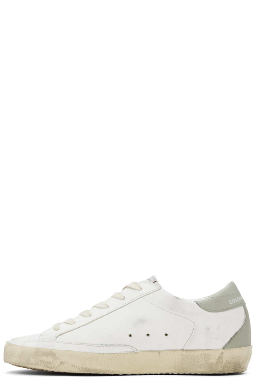 Handcrafted low-top buffed leather sneakers in white.

· Smudging throughout
· Lace-up closure
· Logo patch at tongue
· Padded collar
· Perforated detailing at sides
· Signature star appliqué at outer side
· Gold-tone logo stamp at outer side
· Logo stamp at heel tab
· Terrycloth, suede, and buffed leather lining
· Treaded rubber sole

Supplier color: White/Platinum