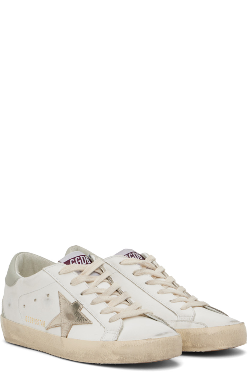 Handcrafted low-top buffed leather sneakers in white.

· Smudging throughout
· Lace-up closure
· Logo patch at tongue
· Padded collar
· Perforated detailing at sides
· Signature star appliqué at outer side
· Gold-tone logo stamp at outer side
· Logo stamp at heel tab
· Terrycloth, suede, and buffed leather lining
· Treaded rubber sole

Supplier color: White/Platinum