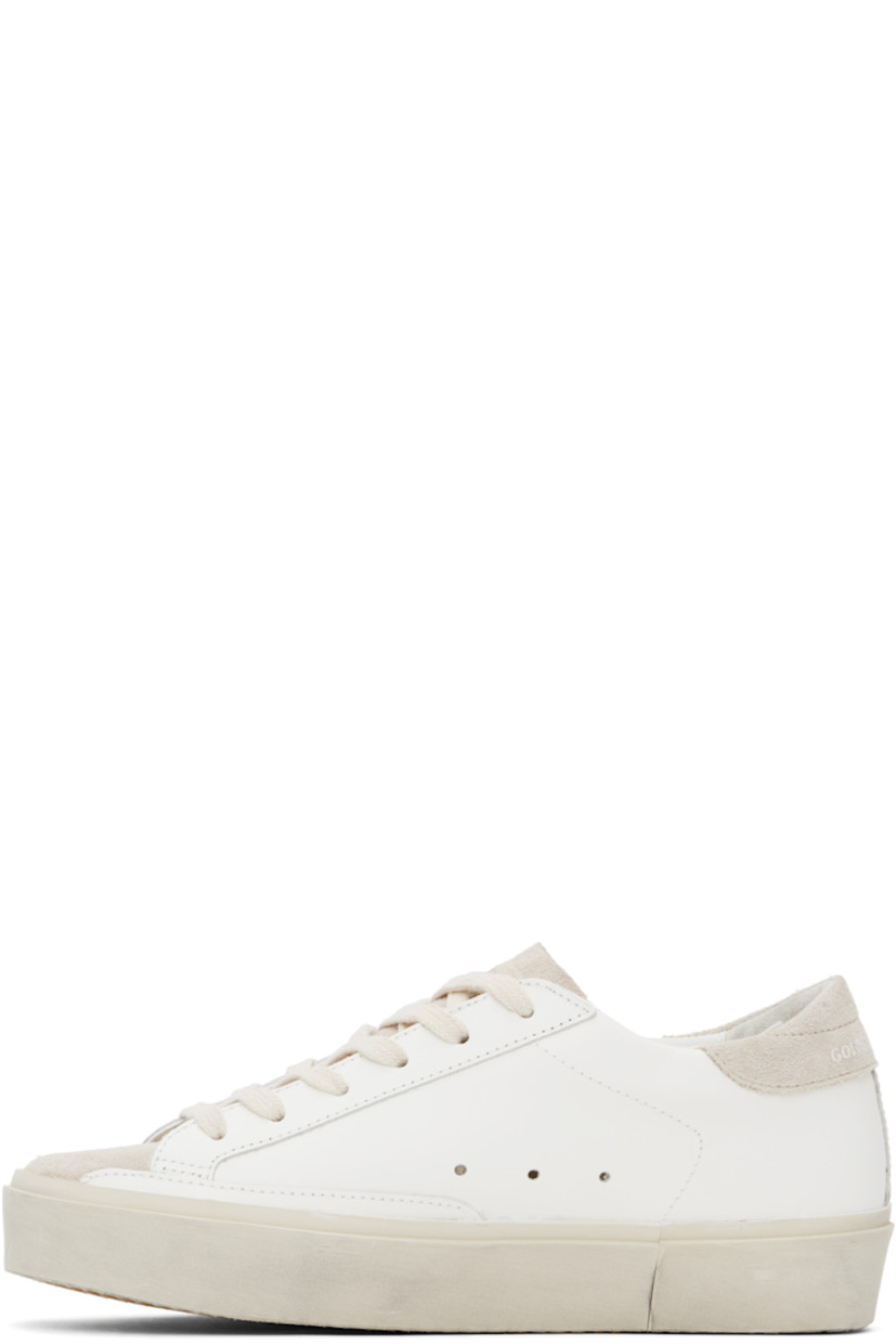 Handcrafted low-top buffed leather and suede sneakers in white and beige.

· Lace-up closure
· Logo stamp at padded tongue
· Padded collar
· Perforated detailing at sides
· Glittered signature star appliqué at outer side
· Gold-tone logo stamp at outer side
· Logo printed at heel tab
· Terrycloth, buffed leather, and suede lining
· Smudging at midsole
· Treaded rubber sole

Supplier color: White/Beige