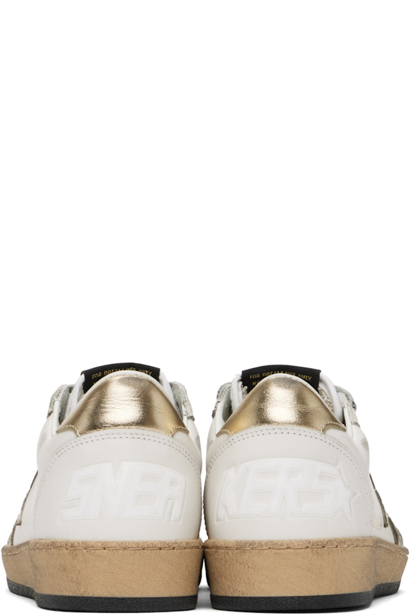 Handcrafted low-top buffed leather sneakers in white.

· Perforations and smudging throughout
· Lace-up closure
· Logo patch at tongue
· Padded collar
· Signature star appliqué at outer side
· Logo stamp at outer side
· Text embossed at heel counter
· Buffed leather, suede, and terrycloth lining
· Textured rubber midsole
· Treaded rubber sole

Supplier color: Milk/Gold