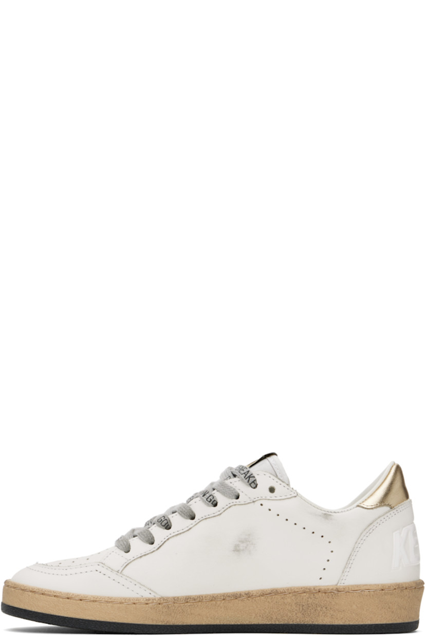 Handcrafted low-top buffed leather sneakers in white.

· Perforations and smudging throughout
· Lace-up closure
· Logo patch at tongue
· Padded collar
· Signature star appliqué at outer side
· Logo stamp at outer side
· Text embossed at heel counter
· Buffed leather, suede, and terrycloth lining
· Textured rubber midsole
· Treaded rubber sole

Supplier color: Milk/Gold