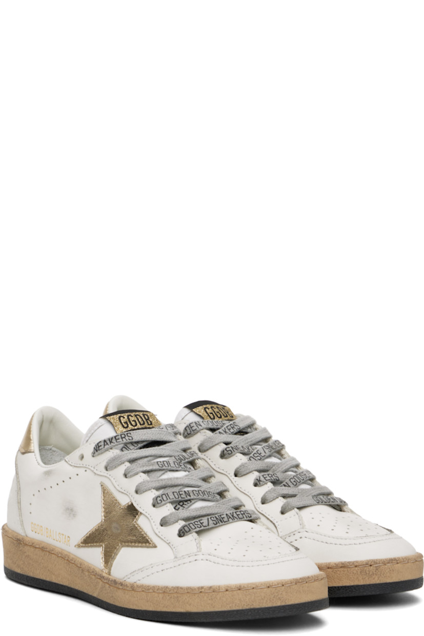 Handcrafted low-top buffed leather sneakers in white.

· Perforations and smudging throughout
· Lace-up closure
· Logo patch at tongue
· Padded collar
· Signature star appliqué at outer side
· Logo stamp at outer side
· Text embossed at heel counter
· Buffed leather, suede, and terrycloth lining
· Textured rubber midsole
· Treaded rubber sole

Supplier color: Milk/Gold