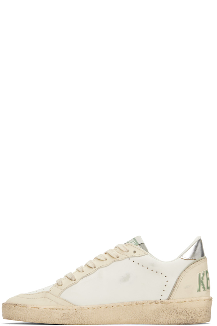 Handcrafted low-top buffed leather sneakers in off-white and khaki.

· Smudging and perforations throughout
· Lace-up closure
· Logo flag at tongue
· Padded collar
· Grained leather star appliqué at outer side
· Logo stamp at outer side
· Text embossed at heel counter
· Grained leather, suede, and terrycloth lining
· Treaded rubber sole

Supplier color: White/Green/Silver