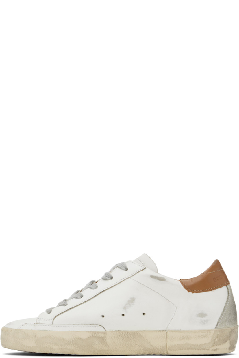 Low-top buffed leather and suede sneakers in white, gray, and brown.

· Distressing and smudging throughout
· Lace-up closure
· Logo perforations at tongue
· Padded collar
· Signature star appliqué at outer side
· Logo stamp at outer side
· Perforated detailing at sides
· Logo embossed at heel counter
· Buffed leather, suede, and terrycloth lining
· Textured rubber midsole
· Treaded rubber sole

Supplier color: White/Ice/Light gray