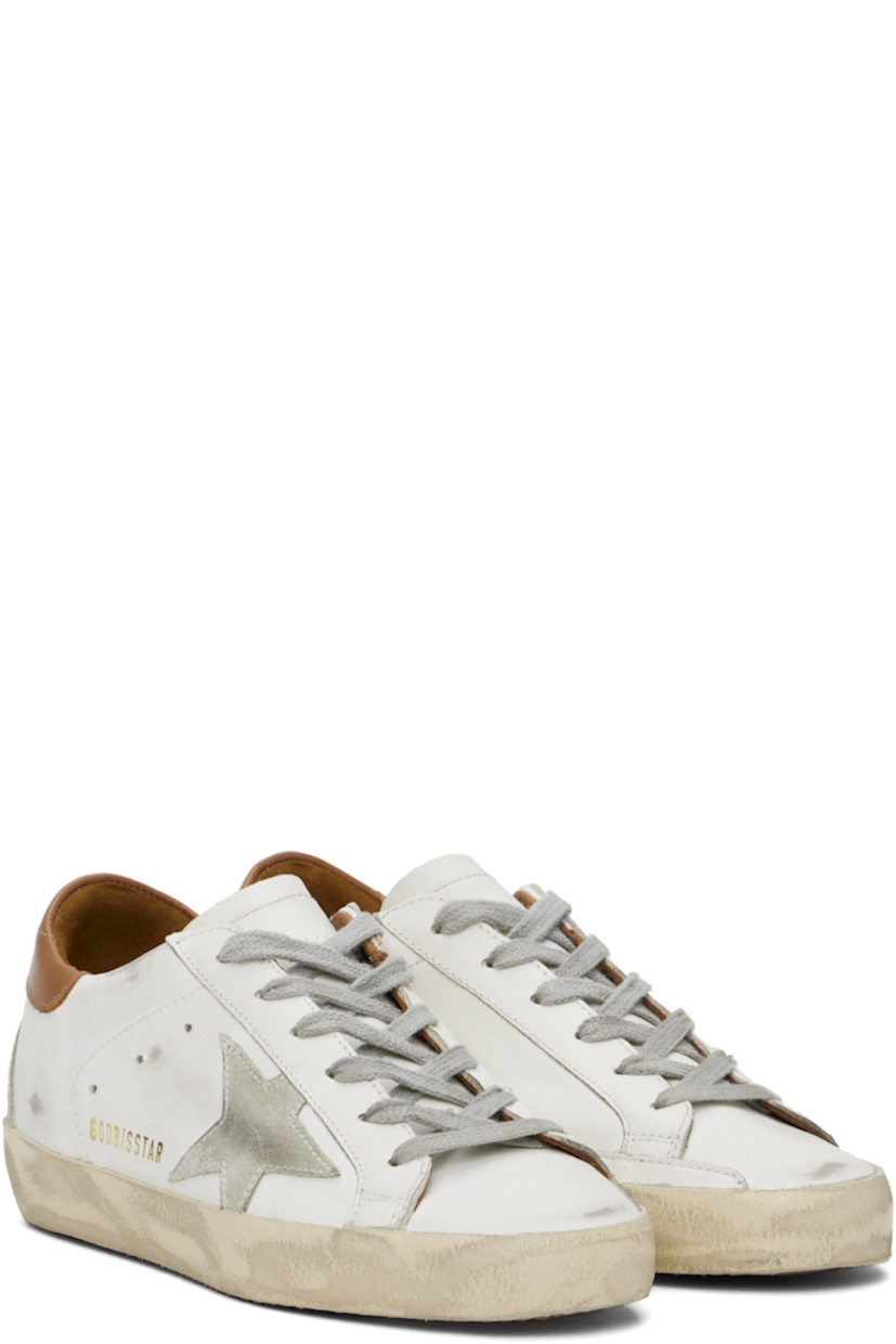 Low-top buffed leather and suede sneakers in white, gray, and brown.

· Distressing and smudging throughout
· Lace-up closure
· Logo perforations at tongue
· Padded collar
· Signature star appliqué at outer side
· Logo stamp at outer side
· Perforated detailing at sides
· Logo embossed at heel counter
· Buffed leather, suede, and terrycloth lining
· Textured rubber midsole
· Treaded rubber sole

Supplier color: White/Ice/Light gray