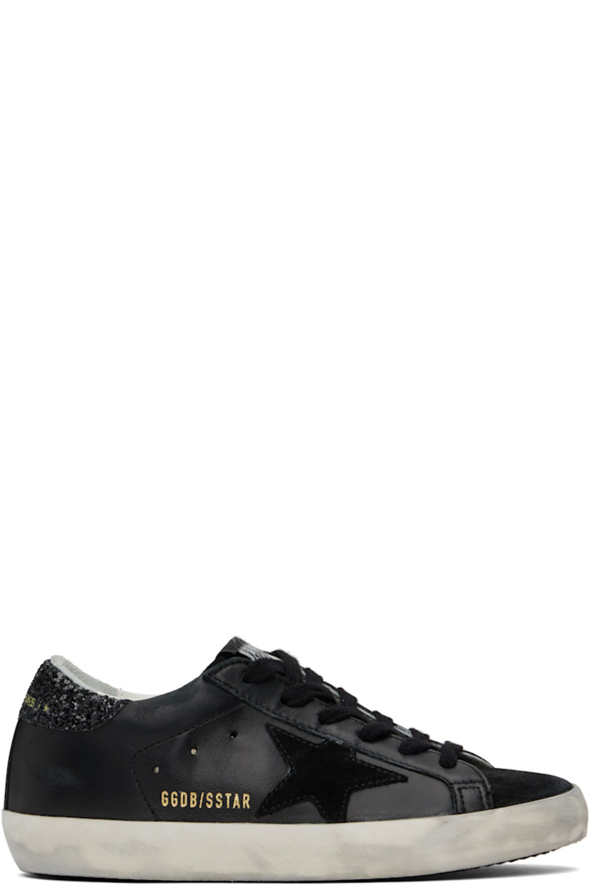 Black low-top paneled buffed sheepskin and suede sneakers in black.

· Smudging throughout
· Lace-up closure
· Logo patch at tongue
· Padded collar
· Signature star appliqué at outer side
· Gold-tone logo stamp at outer side
· Logo printed at glittered heel collar
· Terrycloth, buffed leather, and suede lining
· Treaded rubber sole

Supplier color: Black