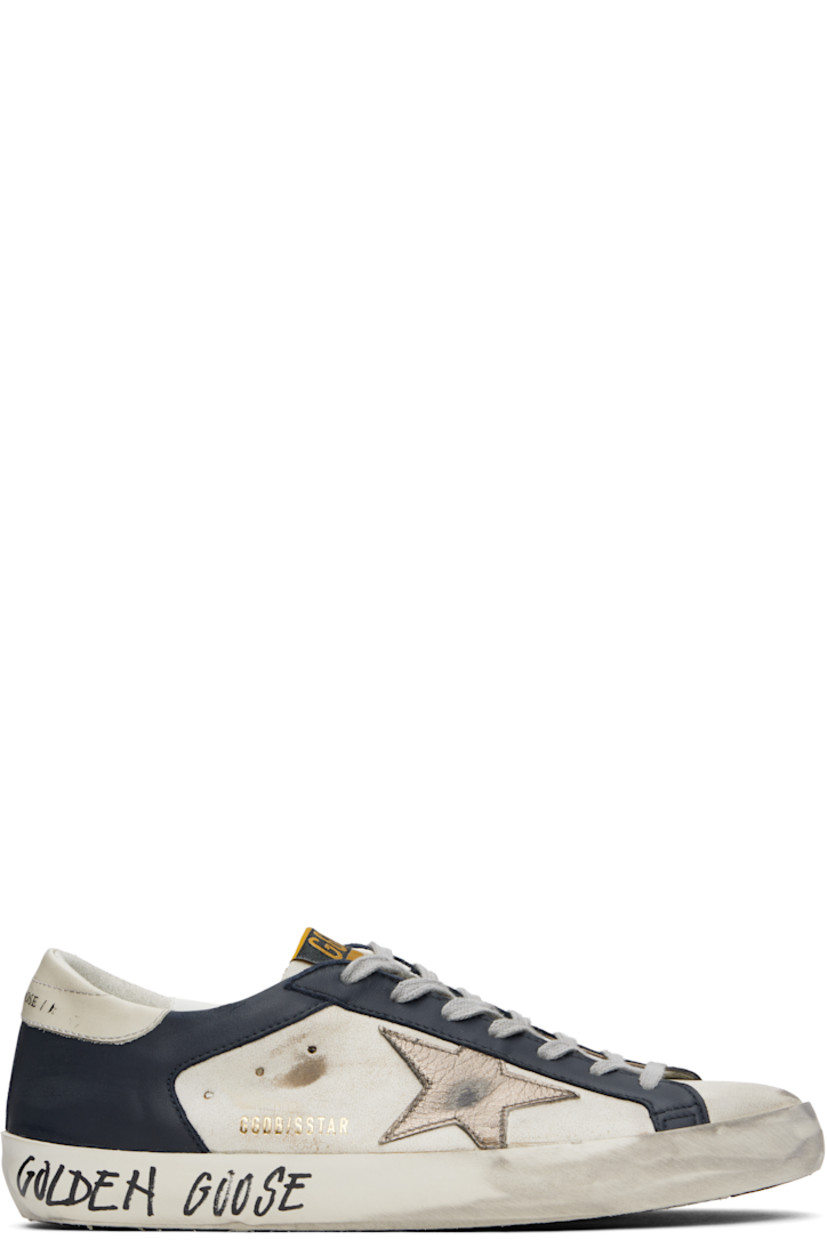 Handcrafted low-top buffed leather and nappa lambskin sneakers in white and navy.

· Smudging and subtle distressing throughout
· Lace-up closure
· Logo flag at tongue
· Padded collar
· Perforations at sides
· Star appliqué and logo stamp at outer side
· Logo printed at heel tab and midsole
· Suede, buffed faux-leather, and terrycloth lining
· Treaded rubber sole

Supplier color: White/Dark blue/Gun metal