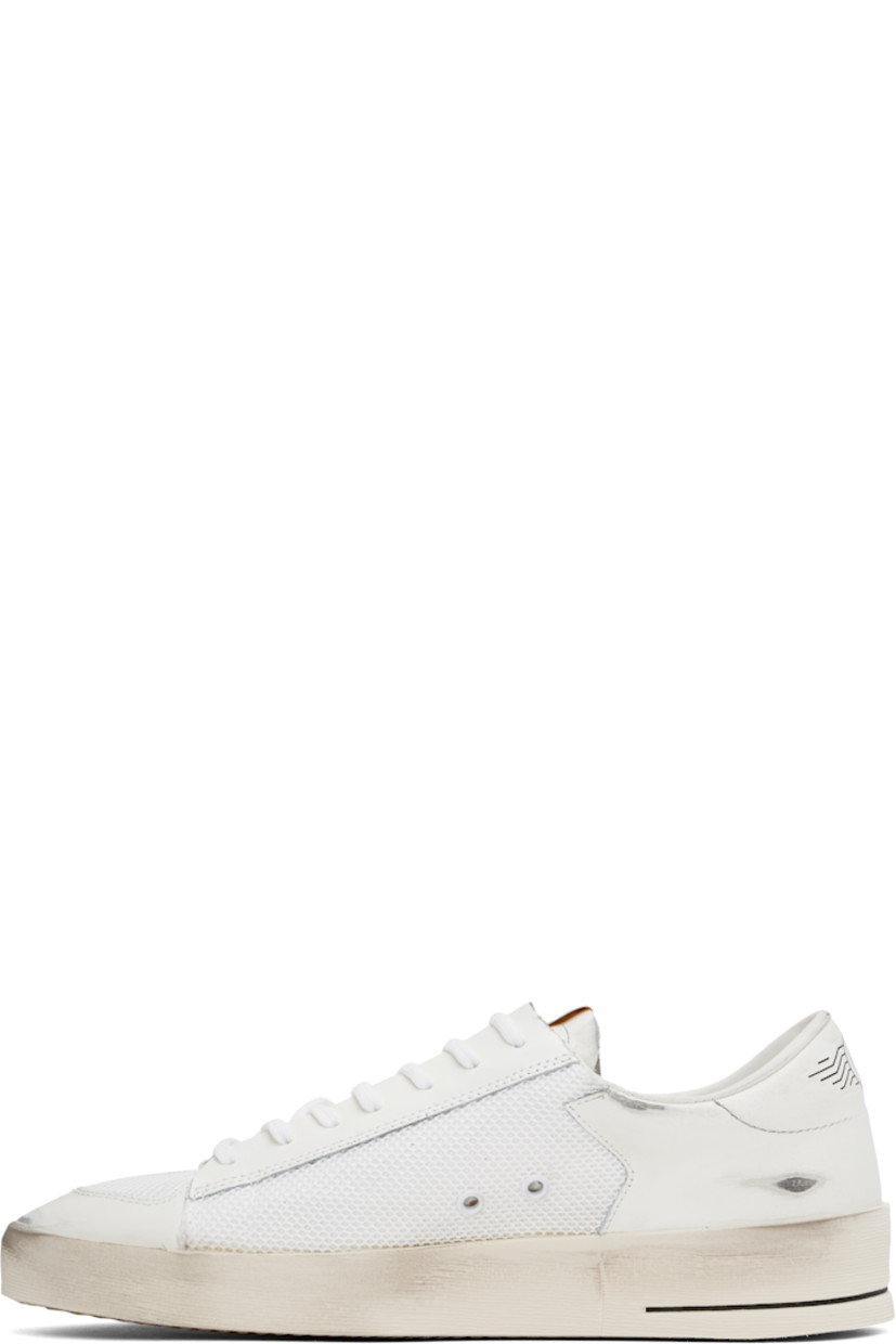 Handcrafted low-top buffed leather and mesh sneakers in white.

· Smudging throughout
· Lace-up closure
· Logo patch at padded tongue
· Padded collar
· Star appliqué and logo stamp at outer side
· Metal eyelets at inner side
· Logo graphic printed at heel tab
· Terrycloth, suede, and buffed leather lining
· Treaded rubber sole

Supplier color: White/Black