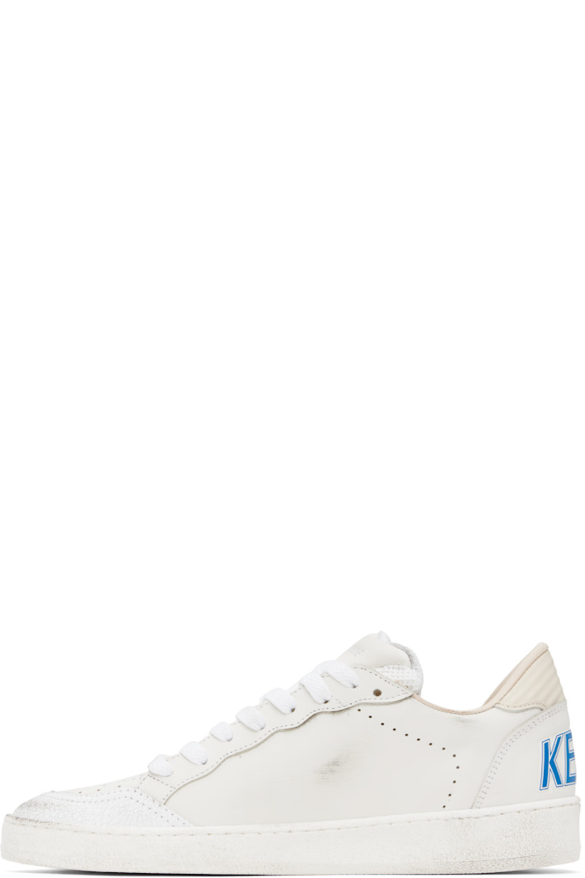 Handcrafted low-top grained leather sneakers in white. 

· Smudging and subtle distressing throughout 
· Crackled trim and perforations at toe
· Lace-up closure
· Logo stamp at padded mesh tongue 
· Star appliqué and logo stamp at outer side
· Perforations at sides
· Stripes embossed at heel tab 
· Logo printed at heel counter 
· Buffed leather, suede, and terrycloth lining 
· Treaded rubber sole 

Supplier color: White/Bluette/Wood