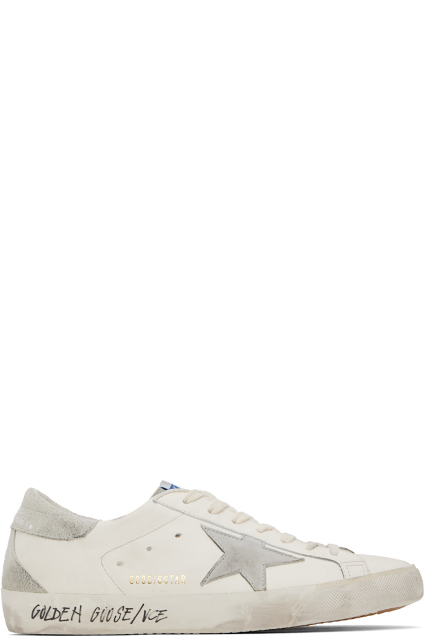 Handcrafted low-top grained sheepskin sneakers in white. 

· Smudging and subtle distressing throughout 
· Lace-up closure
· Logo flag at tongue 
· Padded collar 
· Perforations at sides 
· Star appliqué and logo stamp at outer side
· Logo stamp at suede heel tab
· Buffed leather, suede, and terrycloth lining
· Treaded rubber sole 

Supplier color: White/Ice/Grey