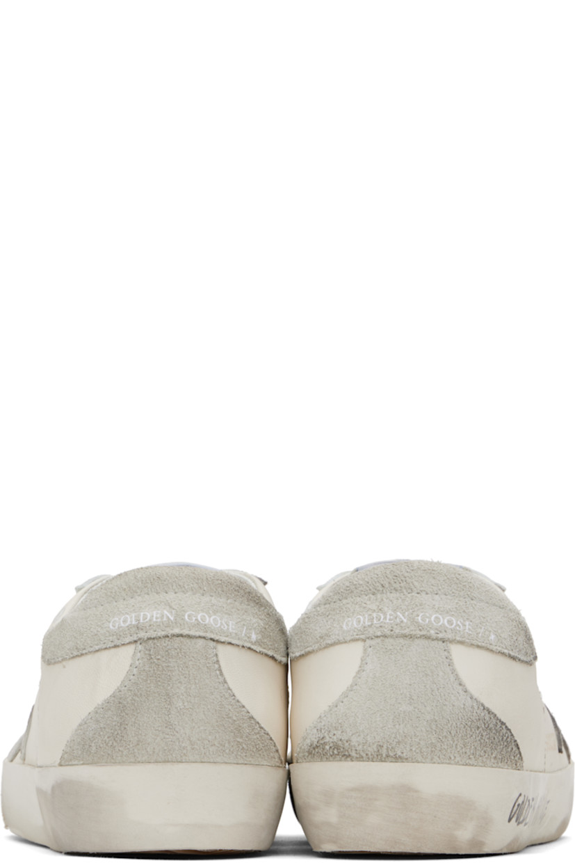 Handcrafted low-top grained sheepskin sneakers in white. 

· Smudging and subtle distressing throughout 
· Lace-up closure
· Logo flag at tongue 
· Padded collar 
· Perforations at sides 
· Star appliqué and logo stamp at outer side
· Logo stamp at suede heel tab
· Buffed leather, suede, and terrycloth lining
· Treaded rubber sole 

Supplier color: White/Ice/Grey