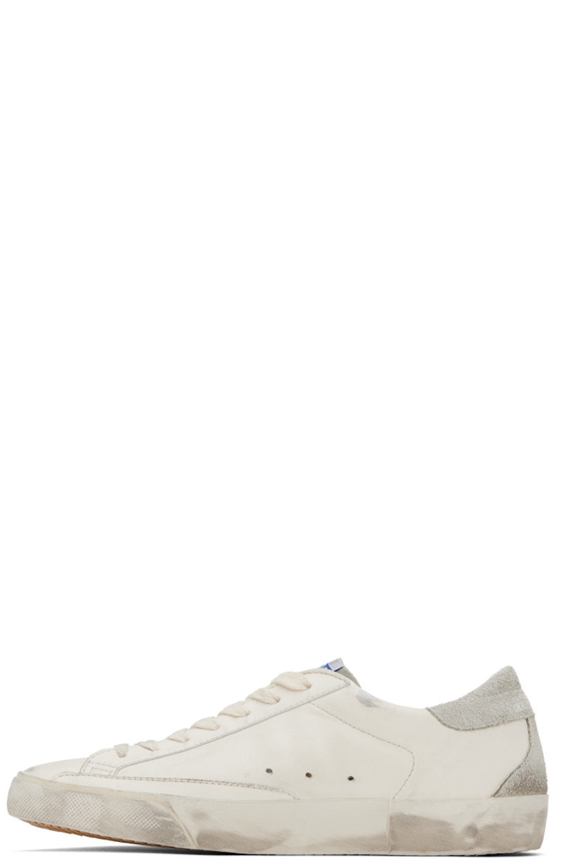 Handcrafted low-top grained sheepskin sneakers in white. 

· Smudging and subtle distressing throughout 
· Lace-up closure
· Logo flag at tongue 
· Padded collar 
· Perforations at sides 
· Star appliqué and logo stamp at outer side
· Logo stamp at suede heel tab
· Buffed leather, suede, and terrycloth lining
· Treaded rubber sole 

Supplier color: White/Ice/Grey