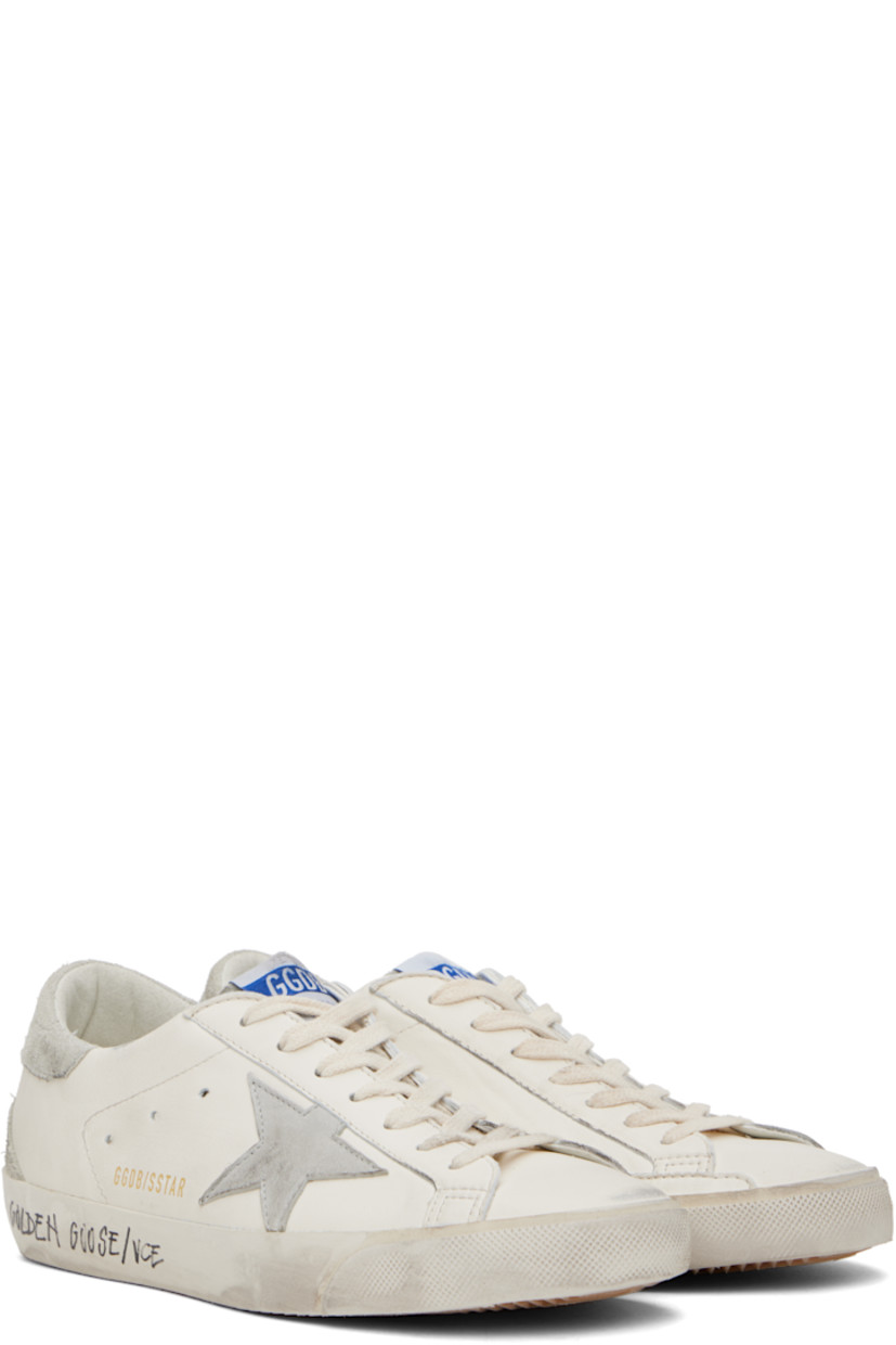 Handcrafted low-top grained sheepskin sneakers in white. 

· Smudging and subtle distressing throughout 
· Lace-up closure
· Logo flag at tongue 
· Padded collar 
· Perforations at sides 
· Star appliqué and logo stamp at outer side
· Logo stamp at suede heel tab
· Buffed leather, suede, and terrycloth lining
· Treaded rubber sole 

Supplier color: White/Ice/Grey