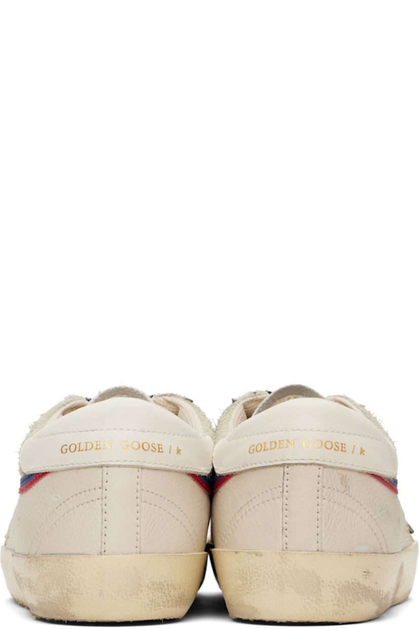 Low-top grained leather and suede sneakers in off-white.

· Smudging and distressing throughout
· Textured rubber cap toe
· Lace-up closure
· Perforated logo at tongue
· Padded collar
· Logo appliqué at sides
· Perforations at sides
· Gold-tone logo stamp at heel tab
· Mesh and terrycloth lining
· Treaded rubber sole

Supplier color: White/Grey