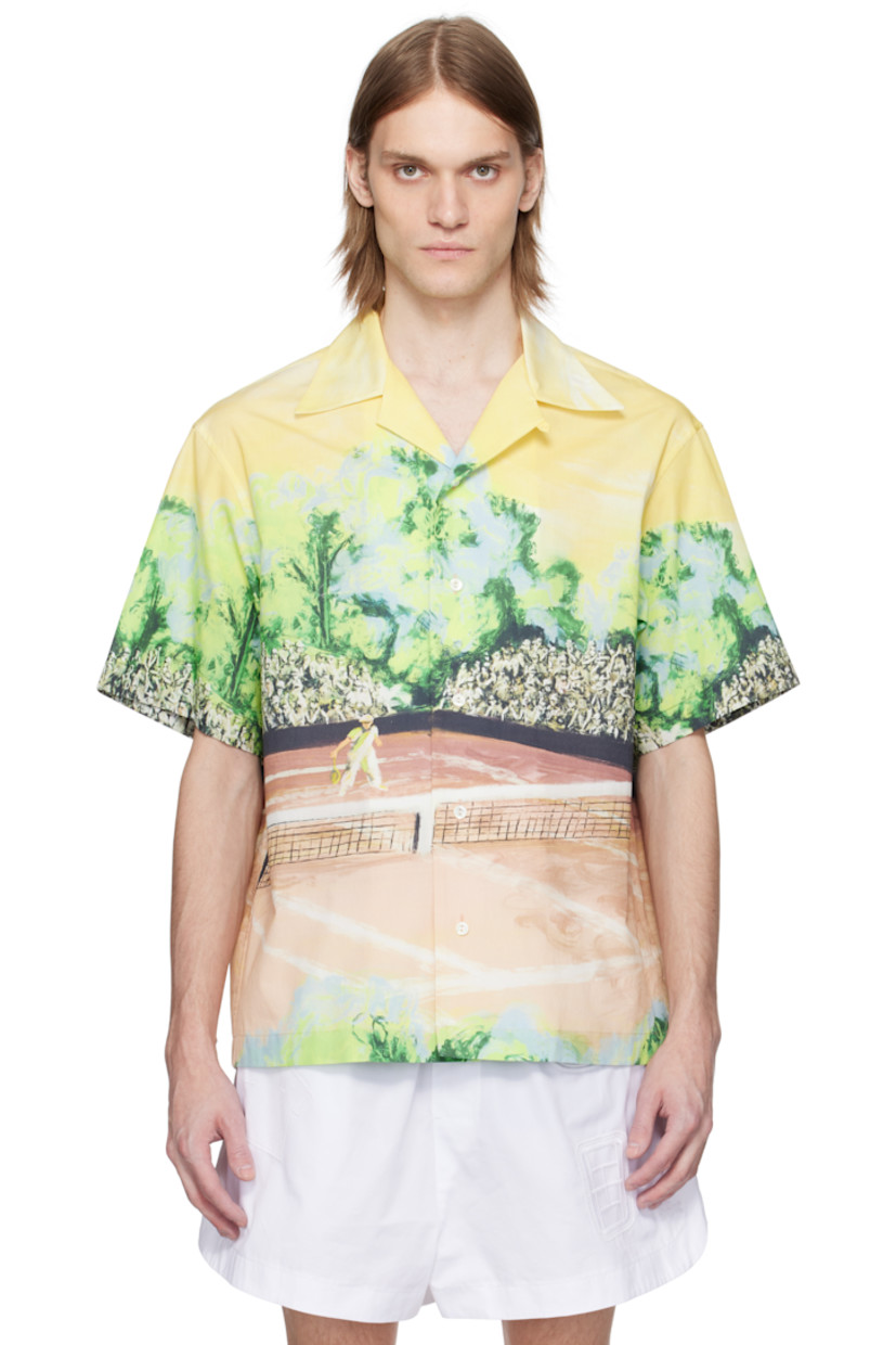 Cotton poplin shirt. Graphic printed throughout. 

· Button fastening at open spread collar
· Button closure
· Embroidered logo patch at back collar
· Twin pleats at yoke 
· Mother-of-pearl hardware

Supplier color: Yellow/Multicolor