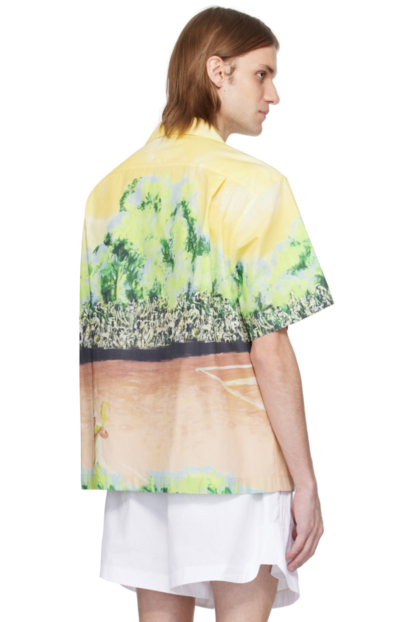 Cotton poplin shirt. Graphic printed throughout. 

· Button fastening at open spread collar
· Button closure
· Embroidered logo patch at back collar
· Twin pleats at yoke 
· Mother-of-pearl hardware

Supplier color: Yellow/Multicolor