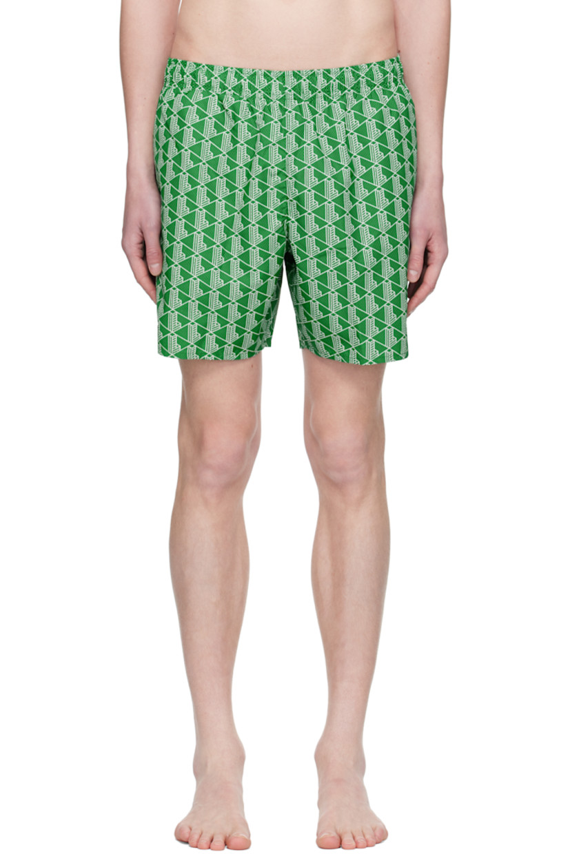 Recycled polyester taffeta swim shorts. Logo graphic pattern printed throughout.

· Concealed drawstring at elasticized waistband
· Three-pocket styling
· Logo graphic patch at back 
· Flap pocket at interior
· Integrated brief-style mesh lining

Supplier color: Green