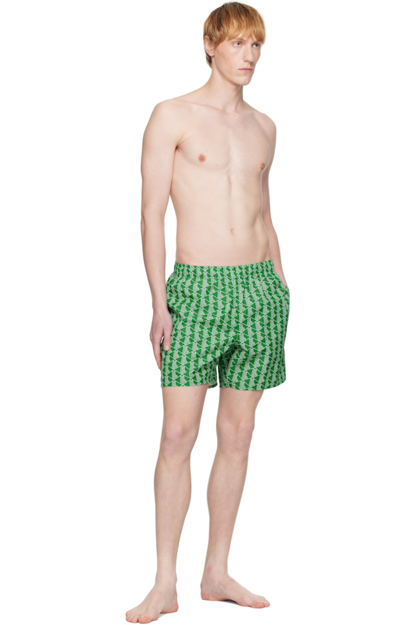 Recycled polyester taffeta swim shorts. Logo graphic pattern printed throughout.

· Concealed drawstring at elasticized waistband
· Three-pocket styling
· Logo graphic patch at back 
· Flap pocket at interior
· Integrated brief-style mesh lining

Supplier color: Green