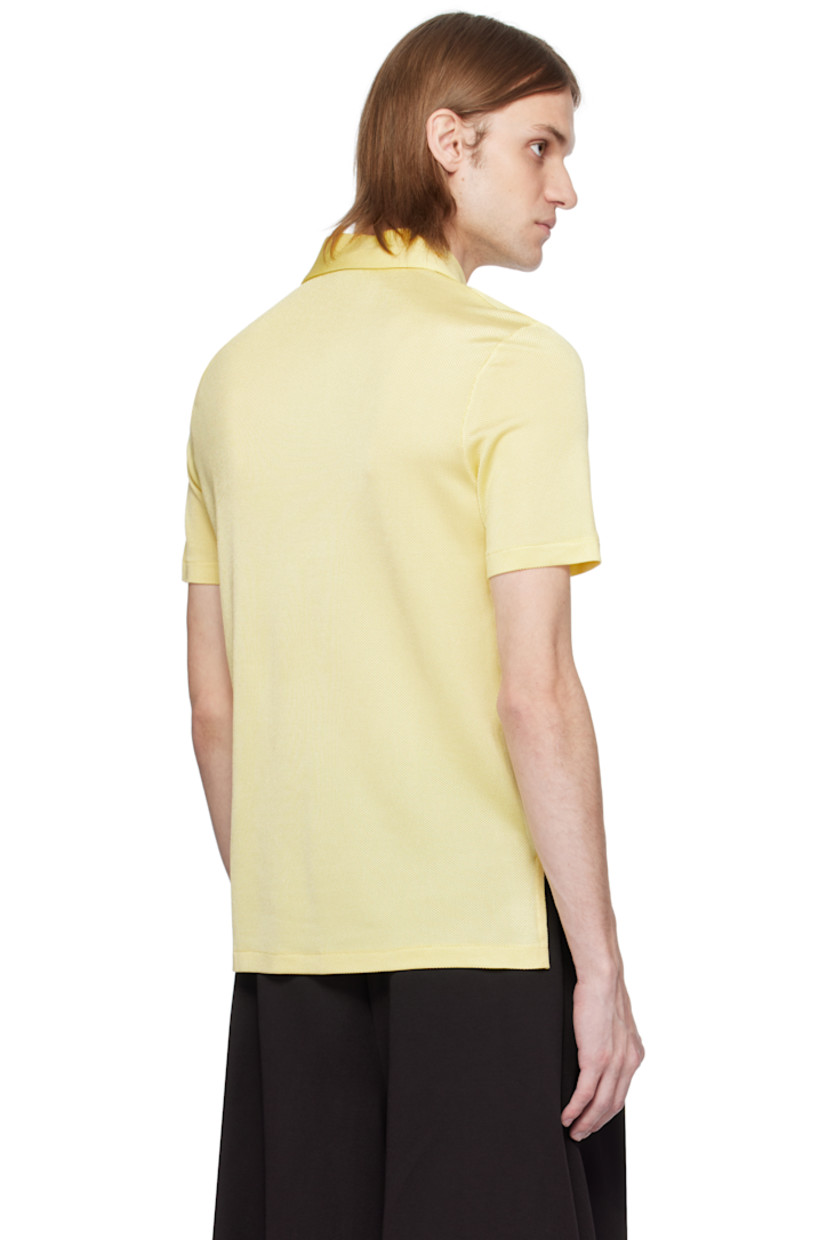 Semi-sheer stretch rayon piqué polo.

· Lightweight 
· Spread collar
· Three-button placket
· Embroidered logo patch at chest and front hem 
· Droptail hem
· Mother-of-pearl hardware

Supplier color: Pastel yellow