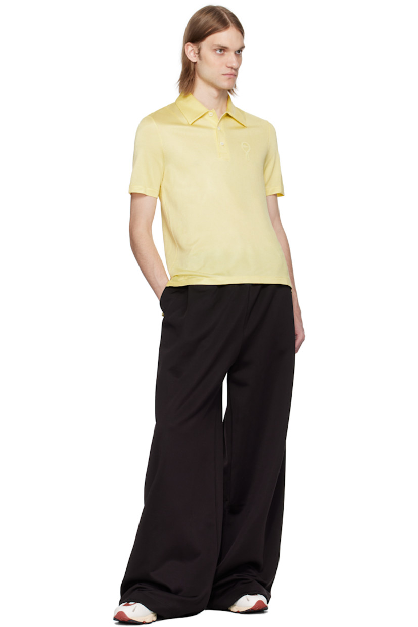 Semi-sheer stretch rayon piqué polo.

· Lightweight 
· Spread collar
· Three-button placket
· Embroidered logo patch at chest and front hem 
· Droptail hem
· Mother-of-pearl hardware

Supplier color: Pastel yellow