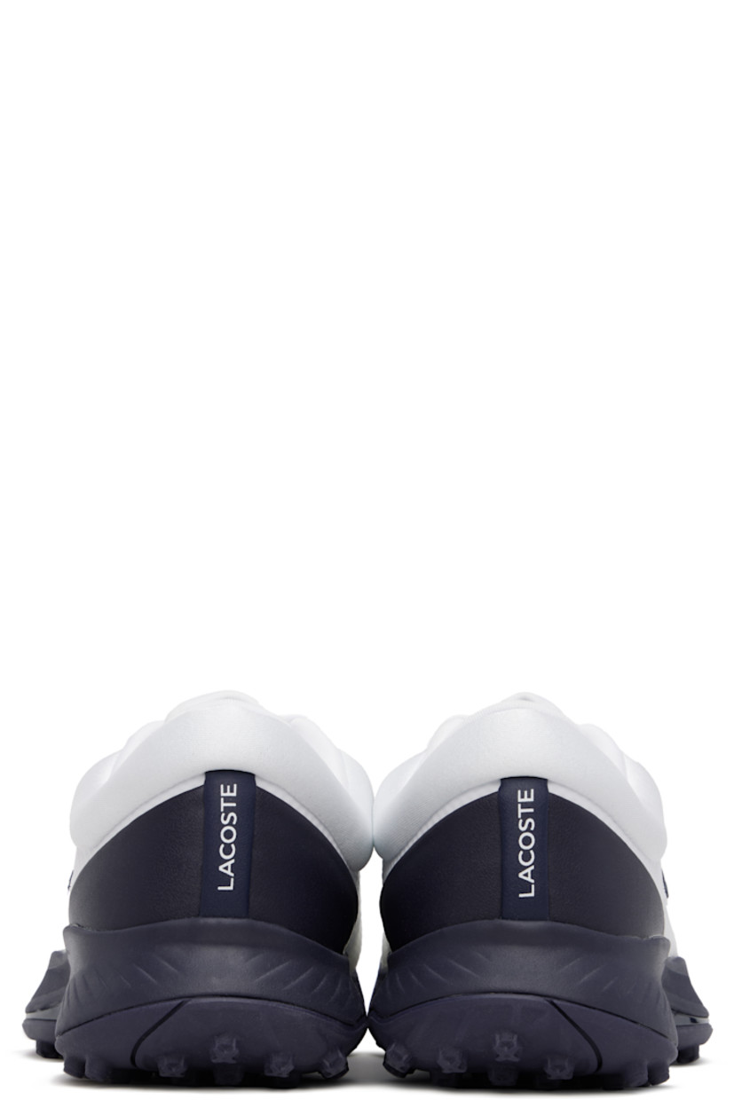 Low-top water-repellent mesh sneakers in white.

· Bonded trim throughout
· Logo embossed at vamp
· Lace-up closure
· Logo printed at tongue and inner side
· Padded tongue and collar
· Rubberized logo patch at outer side
· Logo printed at rubber heel counter
· Ortholite® insole
· Jersey lining
· Treaded rubber sole
· Weight: approx. 529 g each

Supplier color: Wht/Nvy