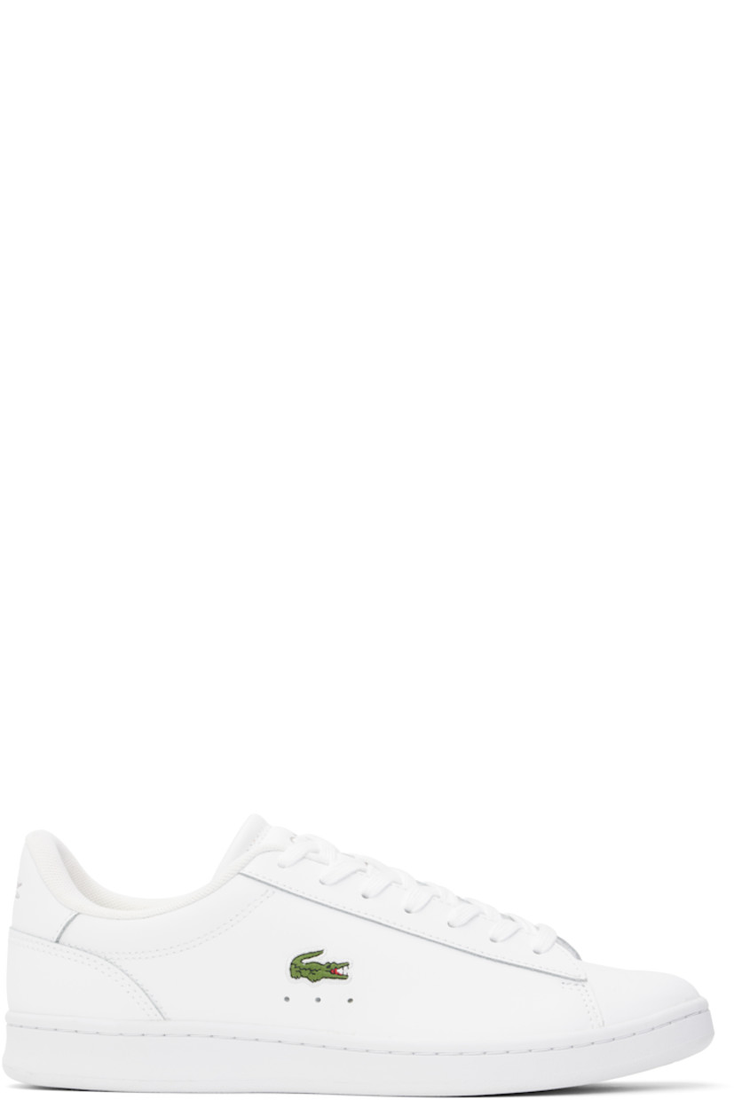 Low-top buffed leather sneakers in white. 

· Lace-up closure
· Logo stamp at padded tongue
· Padded collar
· Perforations at sides
· Logo embroidered at outer side
· Logo embossed at suede heel tab
· Molded OrthoLite® insole
· Mesh lining
· Treaded rubber sole

Supplier color: Wht/Wht
