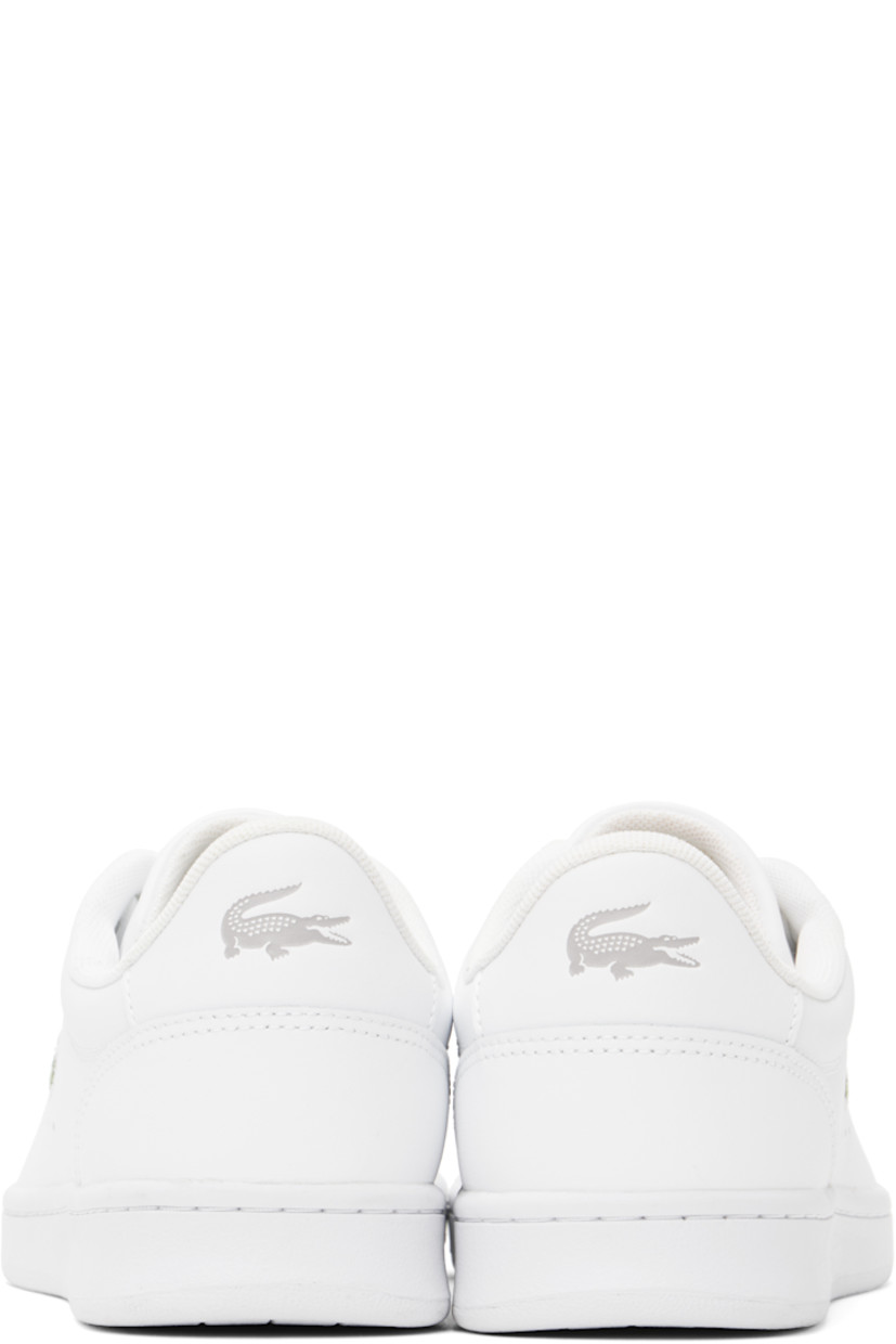 Low-top buffed leather sneakers in white. 

· Lace-up closure
· Logo stamp at padded tongue
· Padded collar
· Perforations at sides
· Logo embroidered at outer side
· Logo embossed at suede heel tab
· Molded OrthoLite® insole
· Mesh lining
· Treaded rubber sole

Supplier color: Wht/Wht