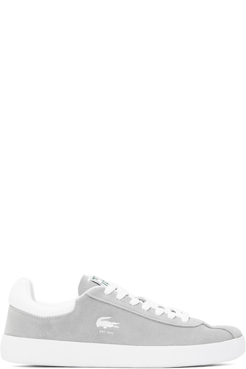 Low-top suede sneakers in gray.

· Lace-up closure
· Logo patch at padded tongue
· Padded collar
· Logo stamp at outer side
· Buffed faux-leather heel tab
· Logo embossed at heel 
· Molded OrthoLite® insole
· Mesh lining
· Treaded rubber sole

Supplier color: Grey/White