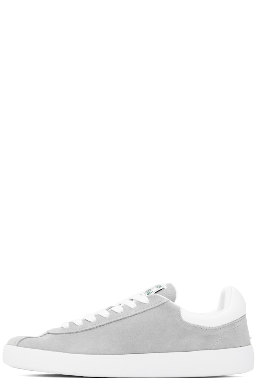Low-top suede sneakers in gray.

· Lace-up closure
· Logo patch at padded tongue
· Padded collar
· Logo stamp at outer side
· Buffed faux-leather heel tab
· Logo embossed at heel 
· Molded OrthoLite® insole
· Mesh lining
· Treaded rubber sole

Supplier color: Grey/White
