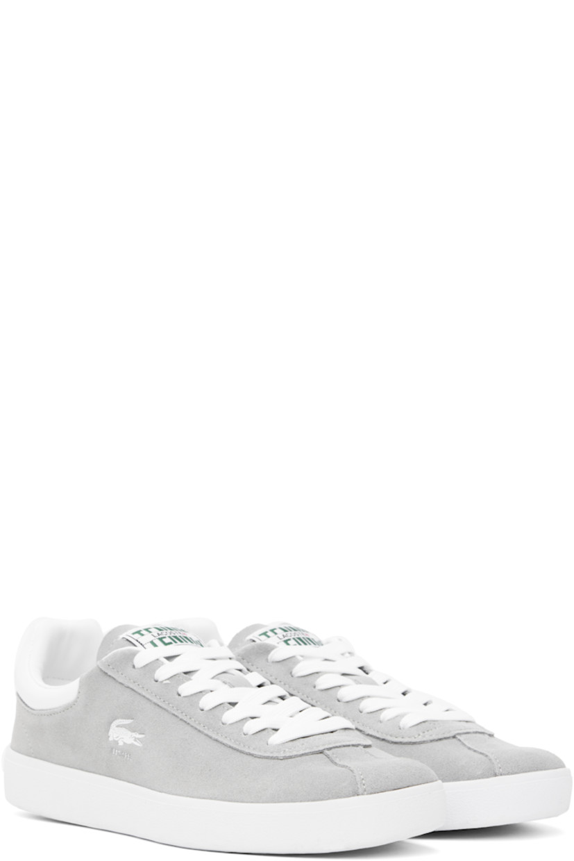 Low-top suede sneakers in gray.

· Lace-up closure
· Logo patch at padded tongue
· Padded collar
· Logo stamp at outer side
· Buffed faux-leather heel tab
· Logo embossed at heel 
· Molded OrthoLite® insole
· Mesh lining
· Treaded rubber sole

Supplier color: Grey/White
