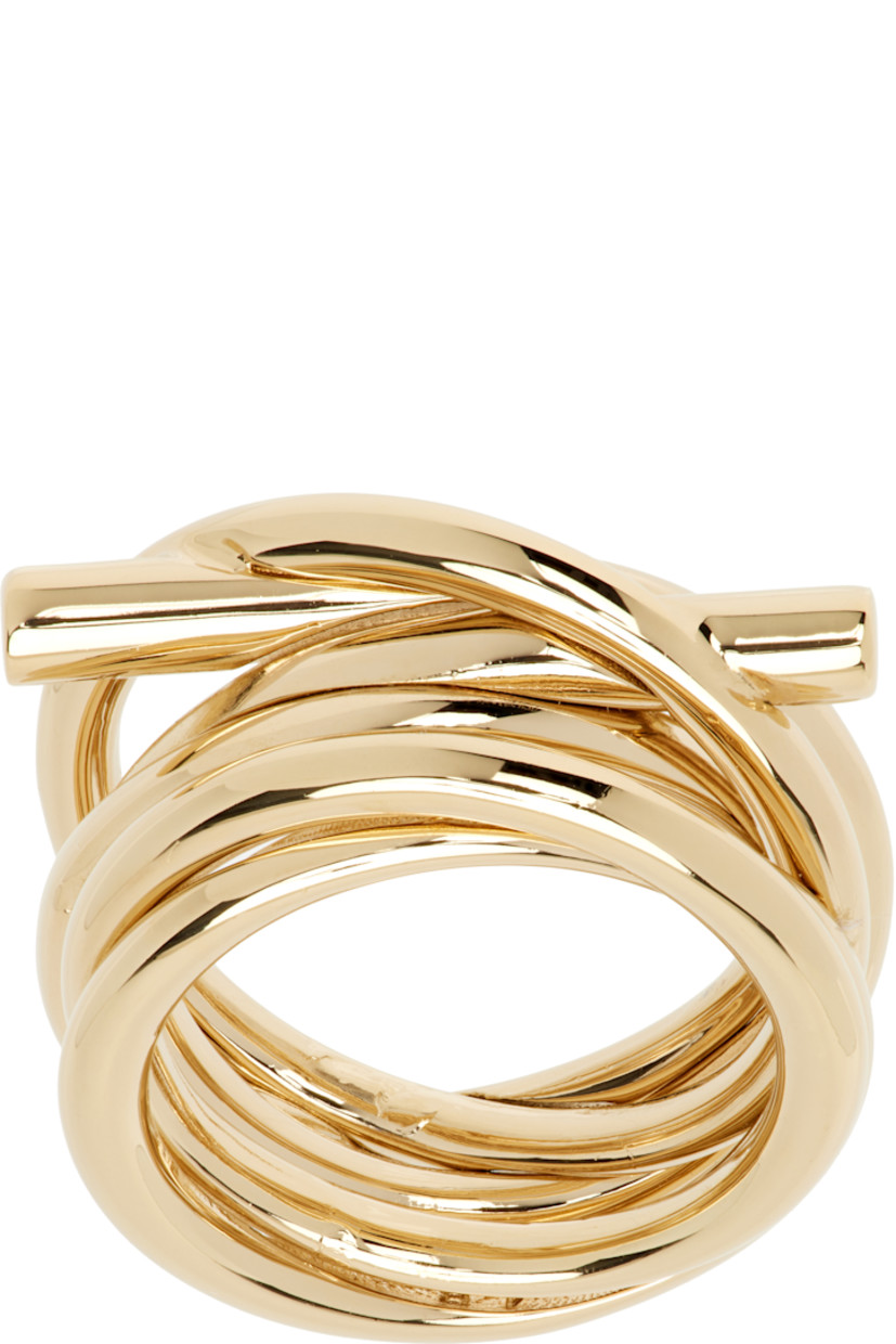 Logo graphic ring in gold-tone brass. Twisting detailing throughout.

Supplier color: Gold