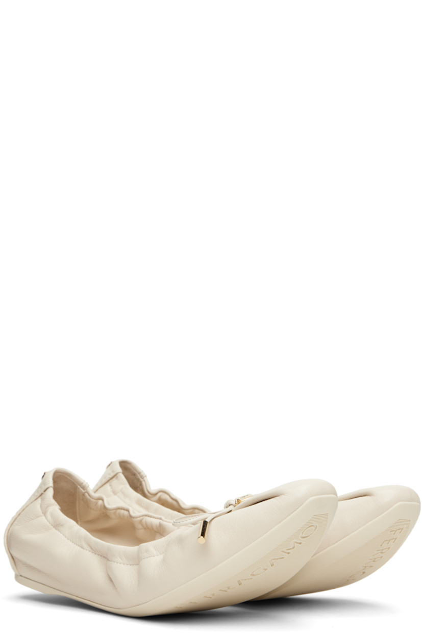 Grained nappa lambskin ballerina flats in off-white. 

· Pointed square toe 
· Logo charm and bow accent at vamp
· Elasticized collar
· Logo hardware at heel collar
· Lambskin lining
· Treaded rubber sole 
· Gold-tone hardware

Supplier color: Mascarpone