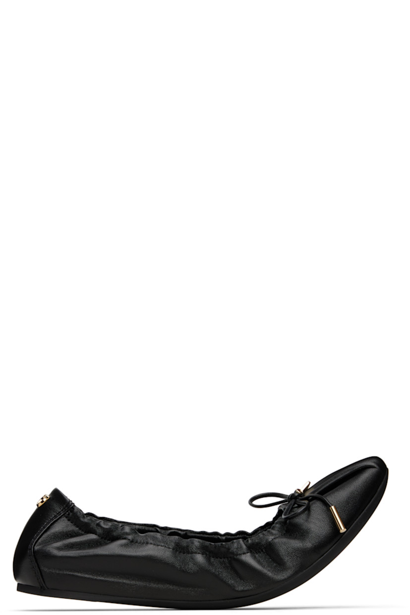 Grained nappa lambskin ballerina flats in black. 

· Pointed square toe 
· Logo charm and bow accent at vamp
· Elasticized collar
· Logo hardware at heel collar
· Lambskin lining
· Treaded rubber sole 
· Gold-tone hardware

Supplier color: Black