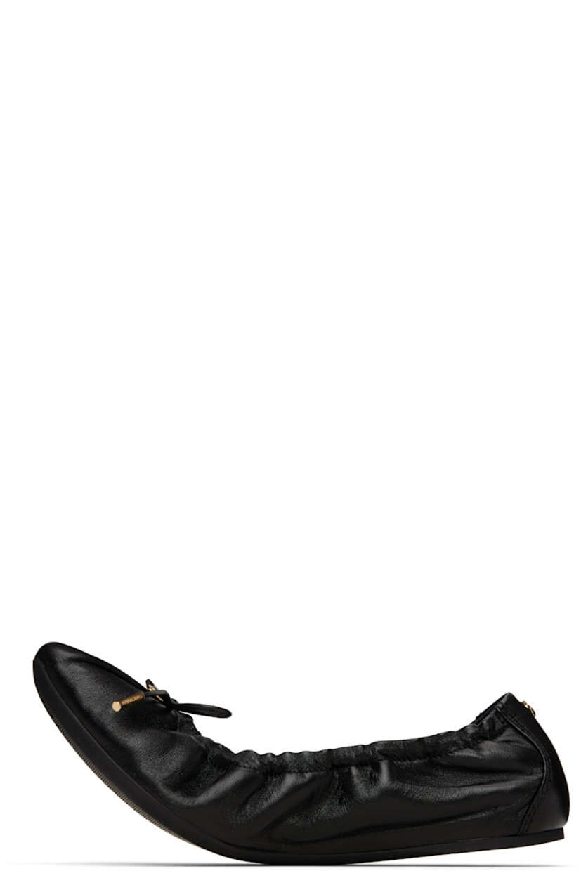 Grained nappa lambskin ballerina flats in black. 

· Pointed square toe 
· Logo charm and bow accent at vamp
· Elasticized collar
· Logo hardware at heel collar
· Lambskin lining
· Treaded rubber sole 
· Gold-tone hardware

Supplier color: Black