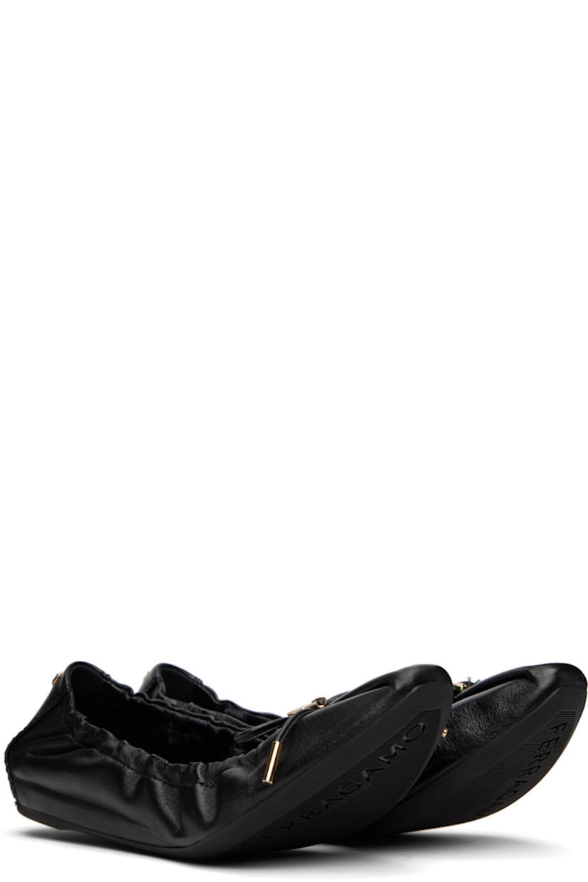 Grained nappa lambskin ballerina flats in black. 

· Pointed square toe 
· Logo charm and bow accent at vamp
· Elasticized collar
· Logo hardware at heel collar
· Lambskin lining
· Treaded rubber sole 
· Gold-tone hardware

Supplier color: Black