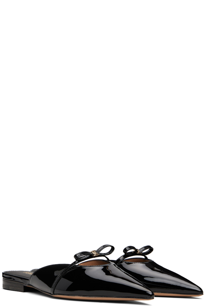 Patent calfskin slippers in black.

· Pointed toe 
· Logo charm and bow accent at vamp
· Logo stamp at footbed
· Goatskin lining 
· Stacked leather heel with rubber injection
· Leather sole 
· Gold-tone hardware

Supplier color: Nero biscotto