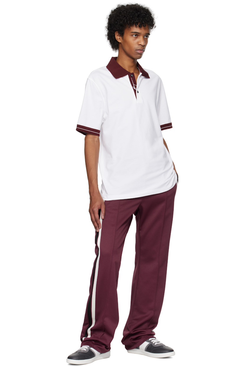 Recycled polyester- and cotton-blend jersey sweatpants.

· Concealed drawstring at elasticized waistband
· Four-pocket styling
· Zip-fly
· Pinched seams at front 
· Stripes at outseams
· Logo embroidered at back pocket

Supplier color: Oxblood/Nero