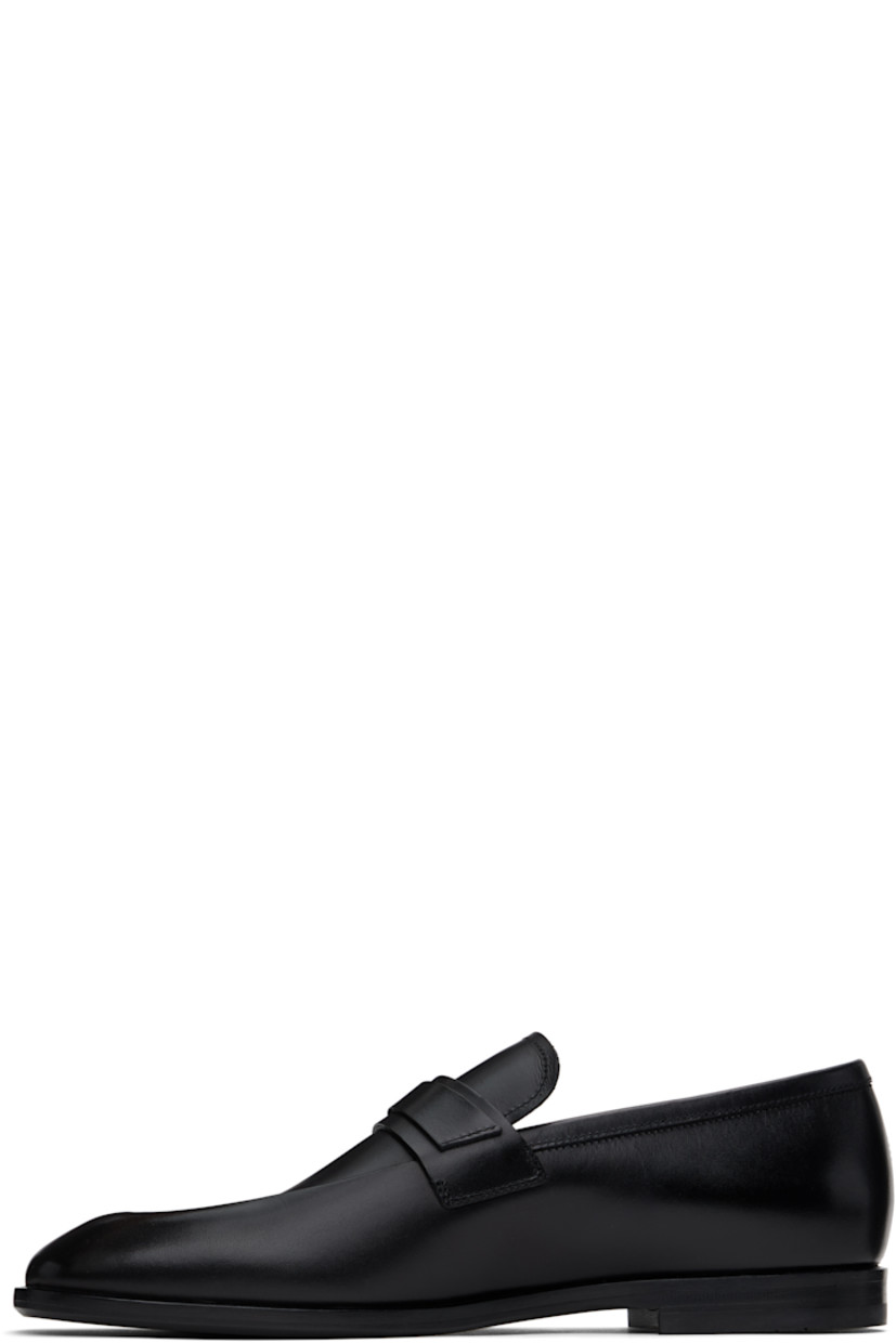 Buffed calfskin loafers in black.

· Moc toe
· Strap and logo hardware at vamp
· Logo stamp at padded footbed
· Buffed calfskin lining
· Stacked leather heel
· Rubber sole
· Logo-engraved hardware

Supplier color: Black