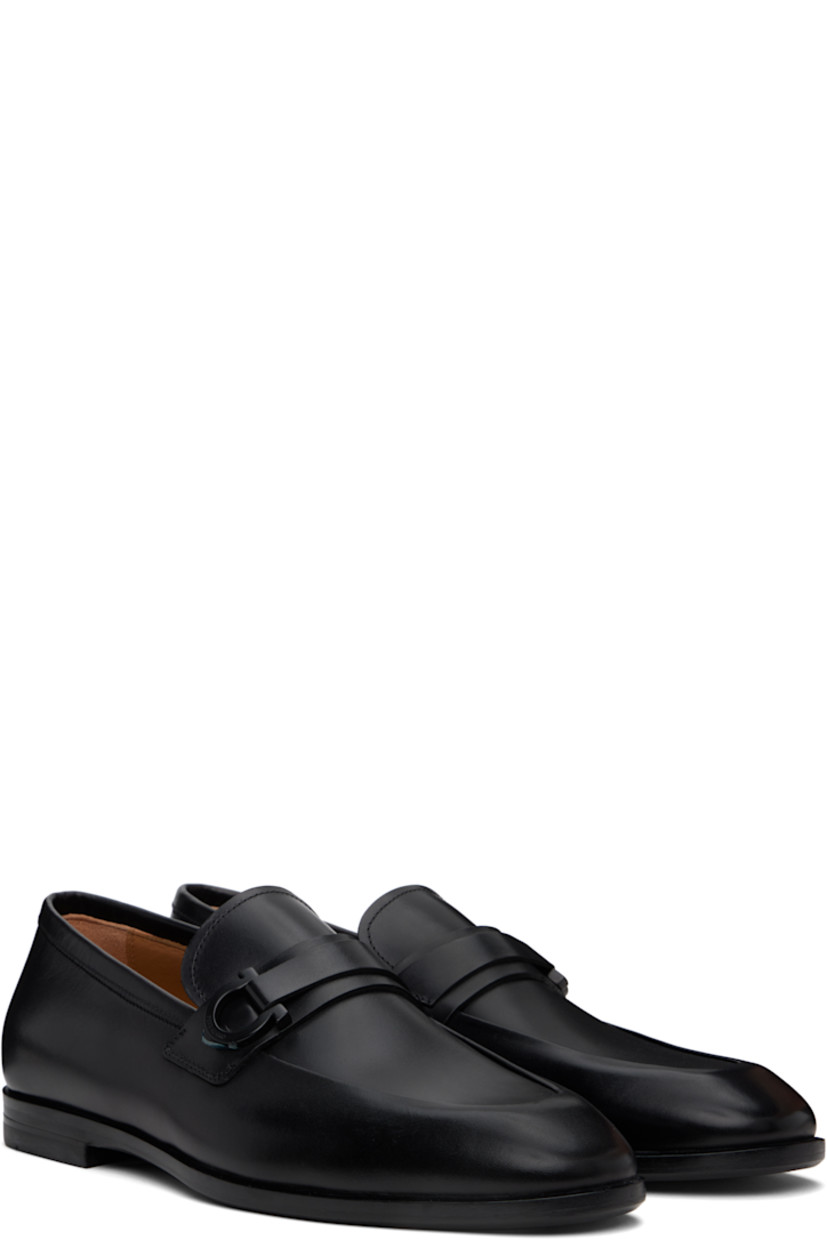Buffed calfskin loafers in black.

· Moc toe
· Strap and logo hardware at vamp
· Logo stamp at padded footbed
· Buffed calfskin lining
· Stacked leather heel
· Rubber sole
· Logo-engraved hardware

Supplier color: Black