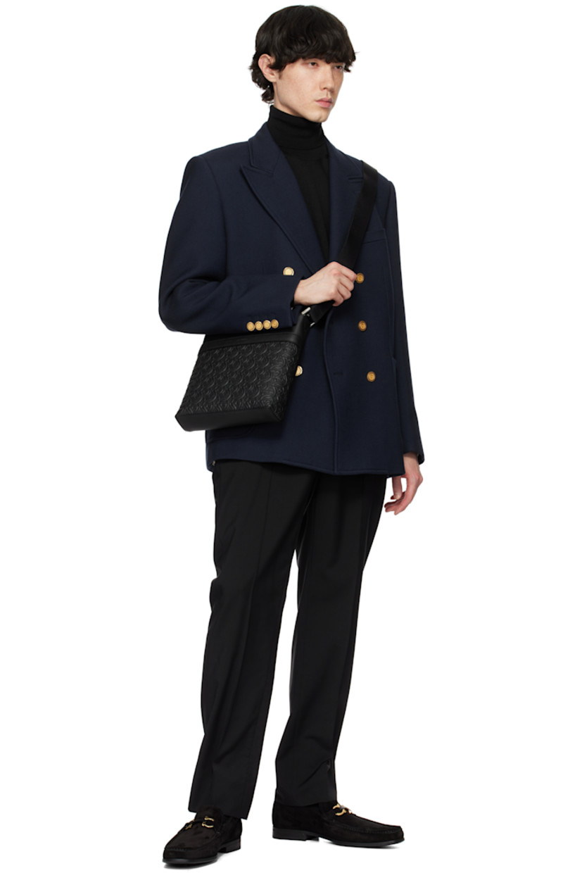 Calfskin suede loafers in black.

· Square moc toe
· Logo hardware at vamp
· Grained leather lining
· Rubber block heel
· Rubber sole
· Gold-tone hardware

Supplier color: Nero