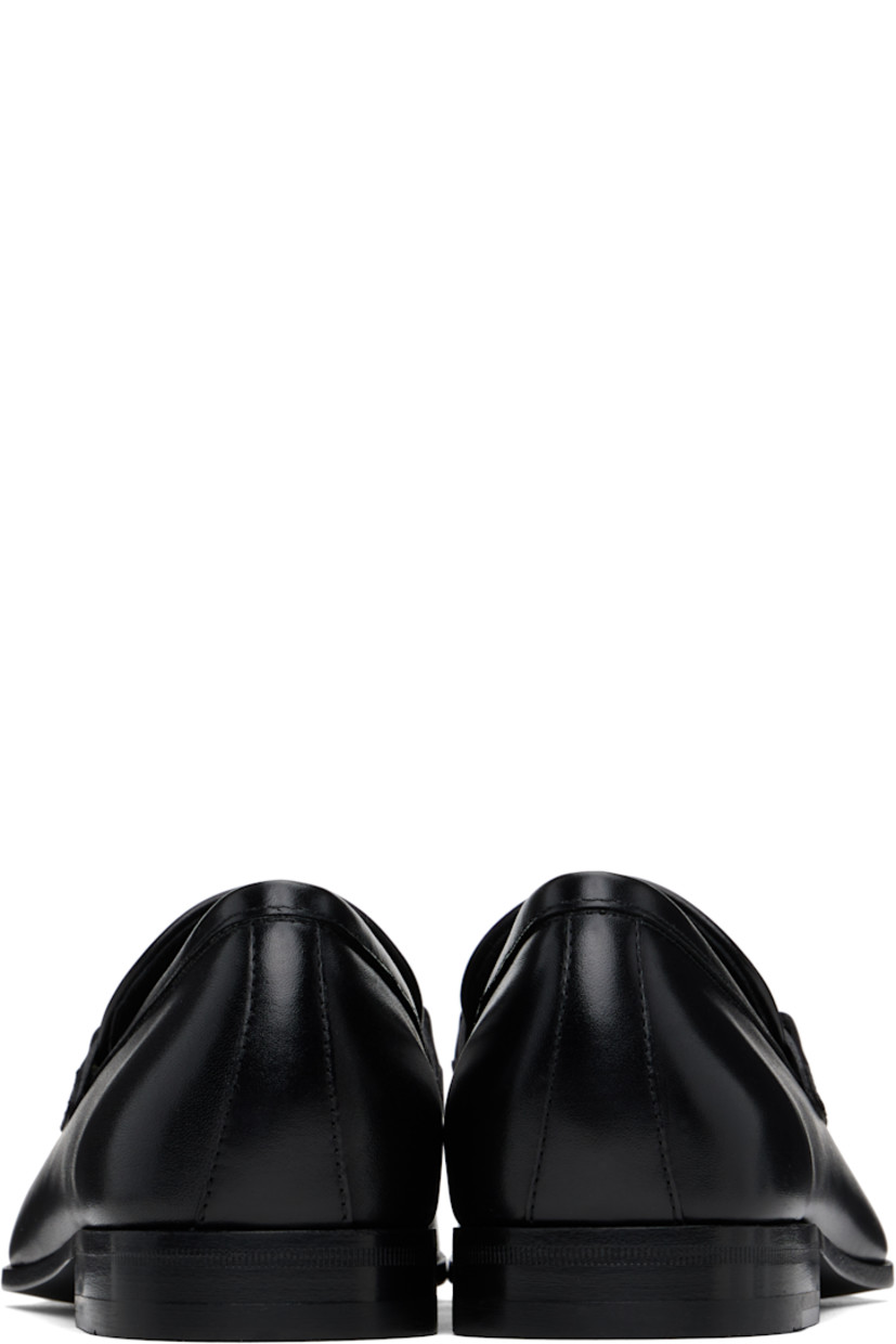 Buffed calfskin loafers in black.

· Moc toe
· Strap and logo hardware at vamp
· Logo stamp at padded footbed
· Buffed calfskin lining
· Stacked leather heel with rubber injection
· Leather sole

Supplier color: Black