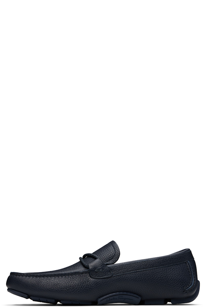 Handcrafted lightweight grained calfskin loafers in navy. 

· Moc toe
· Braided strap and logo hardware at vamp
· Buffed calfskin lining
· Treaded rubber sole

Supplier color: Marine blue
