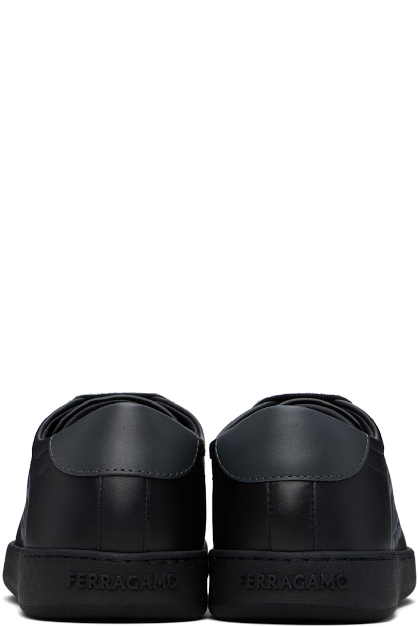 Low-top buffed calfskin sneakers in black. 

· Lace-up closure
· Logo embossed at padded tongue
· Padded collar
· Logo graphic printed at outer side 
· Buffed calfskin lining
· Logo embossed at rubber midsole
· Treaded rubber sole

Supplier color: Black/Stromboli sand