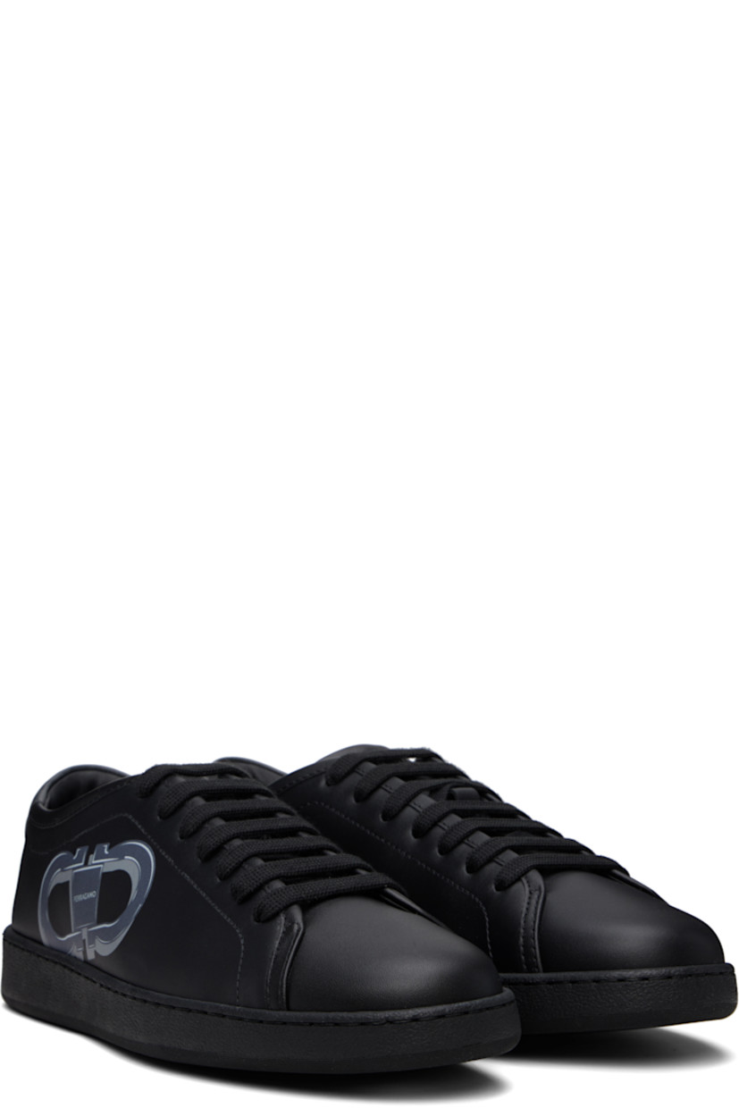 Low-top buffed calfskin sneakers in black. 

· Lace-up closure
· Logo embossed at padded tongue
· Padded collar
· Logo graphic printed at outer side 
· Buffed calfskin lining
· Logo embossed at rubber midsole
· Treaded rubber sole

Supplier color: Black/Stromboli sand