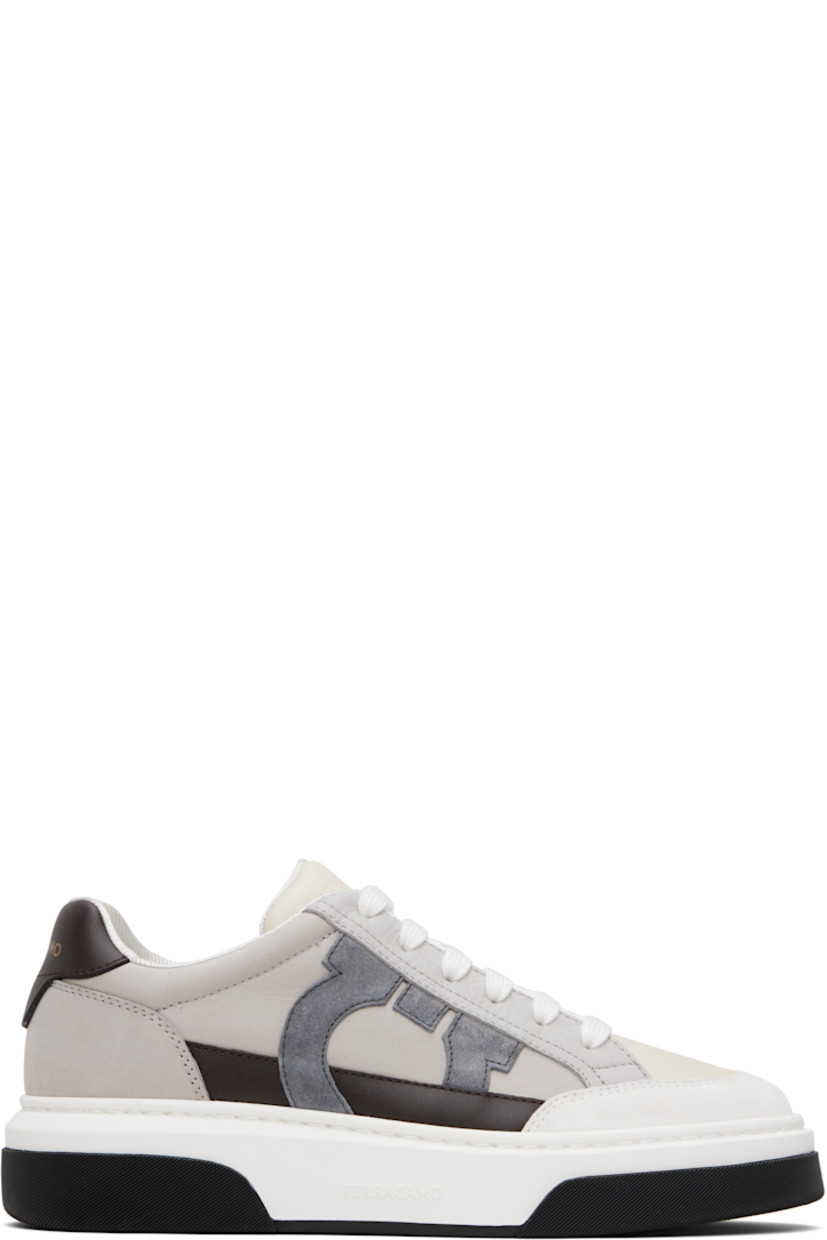 Low-top suede, buffed calfskin, and grained calfskin sneakers in gray and off-white. 

· Lace-up closure
· Logo embossed at padded tongue
· Padded collar
· Logo appliqué at outer side
· Logo printed at heel tab
· Mesh lining
· Logo embossed at rubber midsole
· Textured rubber sole

Supplier color: White/Mascarpone