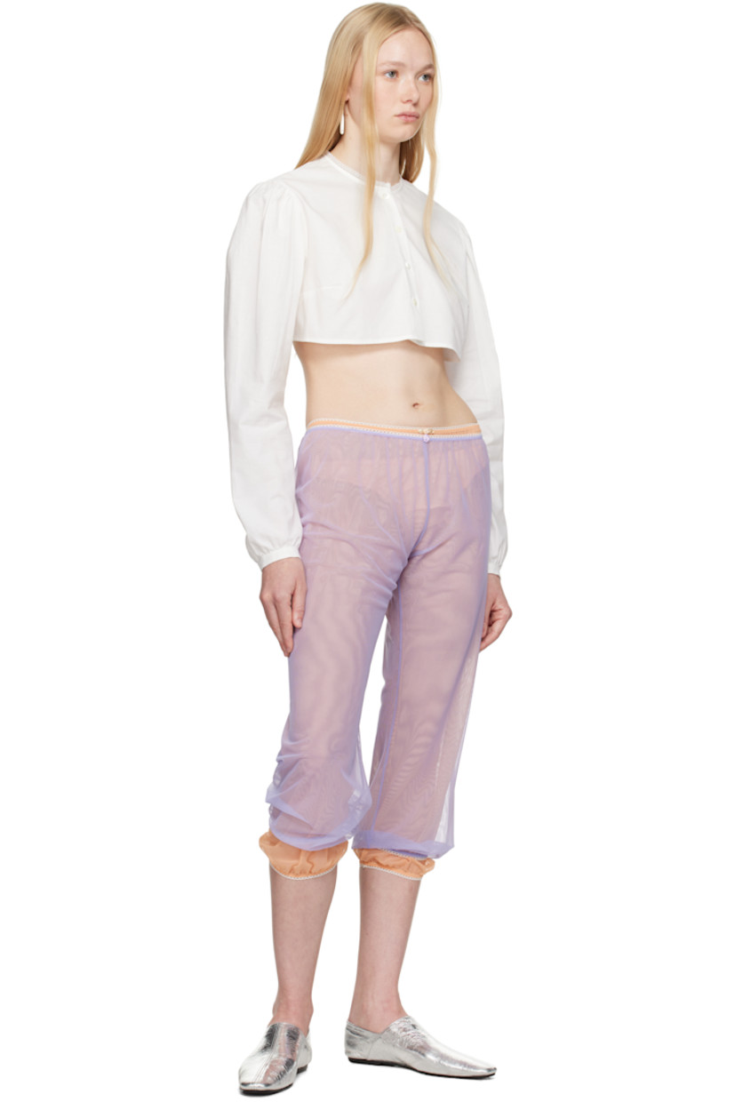 Sheer nylon tulle trousers.

· Scalloped edge at elasticized waistband and cuffs
· Floral appliqué at front waistband
· Cropped legs

Supplier color: Peach