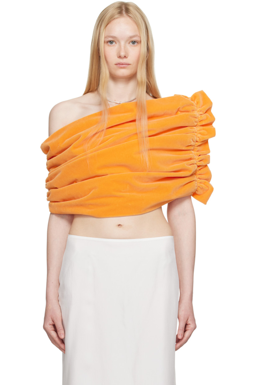 Cotton velvet top.

· Asymmetrical off-the-shoulder construction
· Ruching at sides
· Ruffled trim at side
· Full poplin lining

Supplier color: Peach